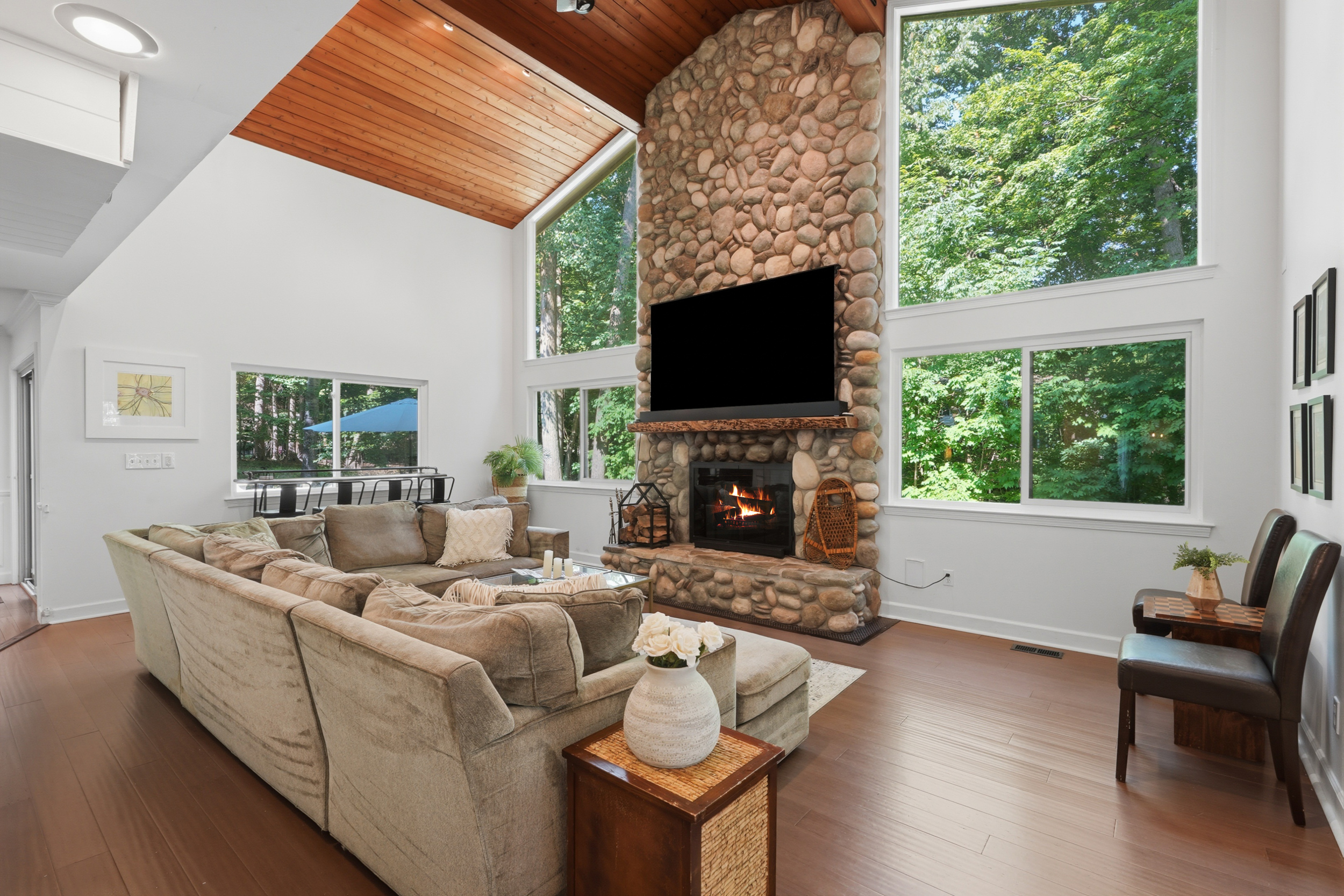 Vaulted great room with fieldstone fireplace and tall windows