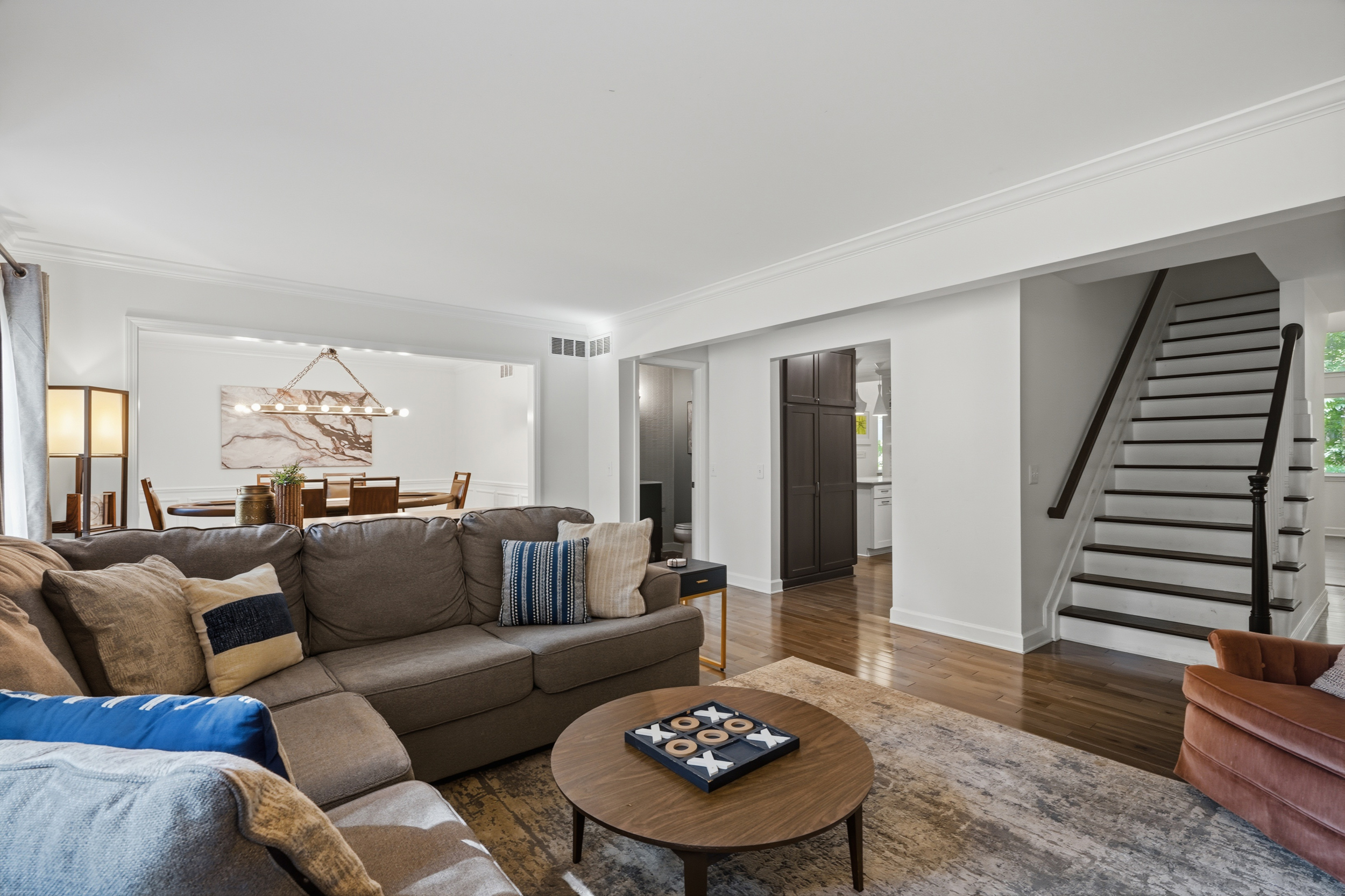 Living room opening to the dining room and staircase