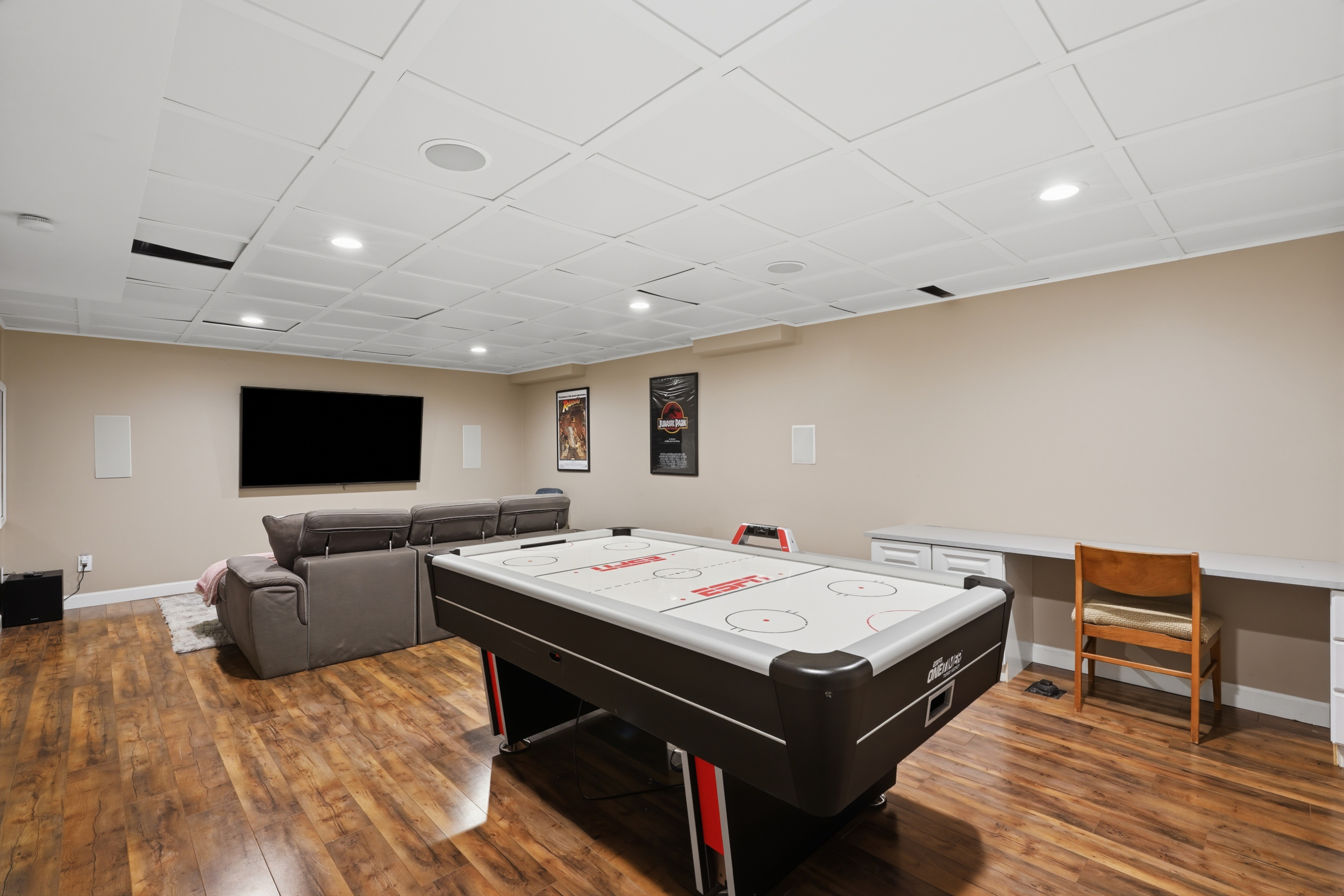 Finished recreation room with theater seating and air hockey