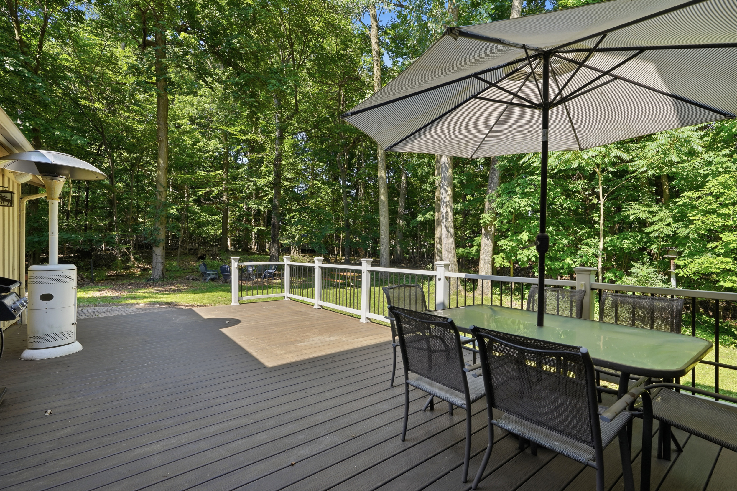 Large rear deck overlooking the wooded yard